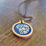 large wood hoop pendant with embroidered daisies